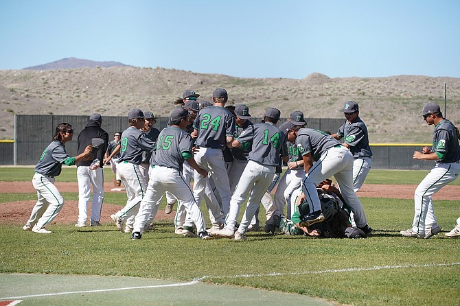 The Greenwave baseball team celebrates near the mound after defeating Dayton on Wednesday for the Northern 3A East championship.