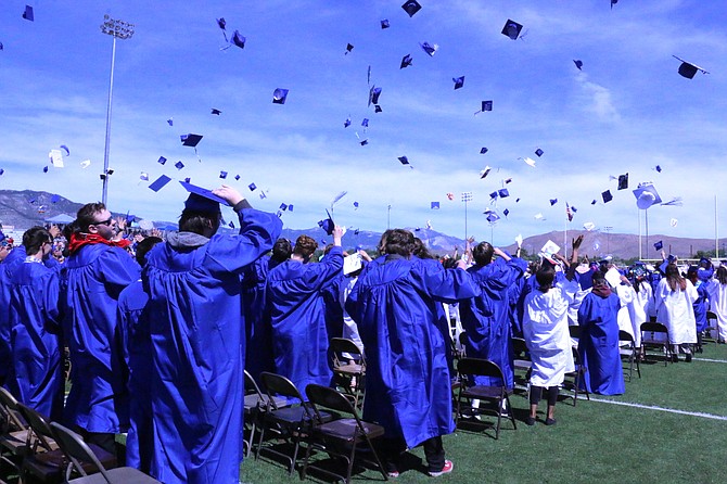 Carson High School’s graduates toss their caps in celebration Saturday.