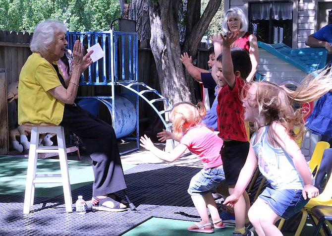Rosetta McFadden, left, leads a group of children during her final graduation ceremony at Kinderland Thursday while her daughter, Malah McFadden, center, watches. The two owners of Kinderland, which began in Carson City in 1964, are retiring and have called on Caitlin Castaneda to take over the business, who will be reopening the preschool later this summer as Kinderland Cottage. (Photo: Jessica Garcia/Nevada Appeal)
