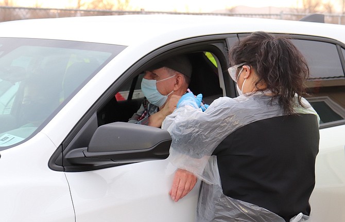 A man receives his COVID vaccination at the Churchill County Public Health drive-through site.