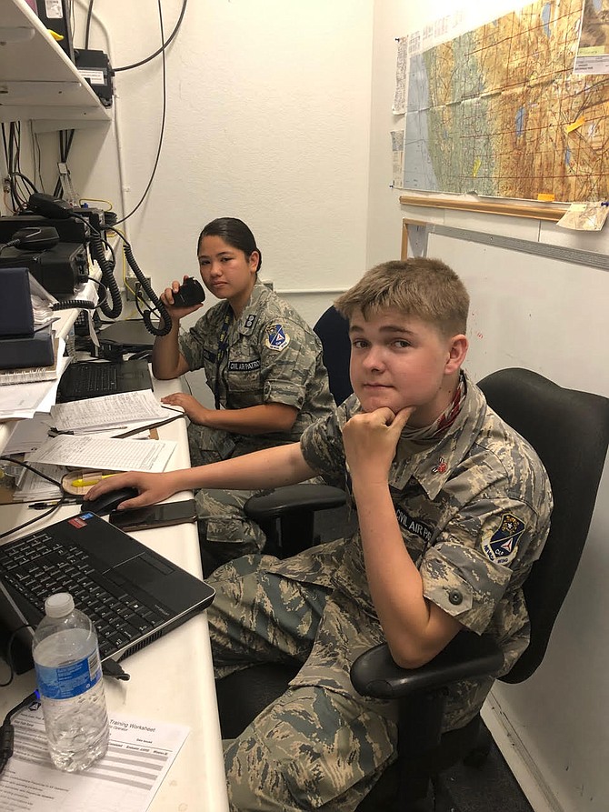 Cadet 1st Lt. Luz Sandoval, left, and Cadet Airman First Class Devin Linehan, right, on duty in the comm room at the Douglas County Composite Squadron in Minden.
