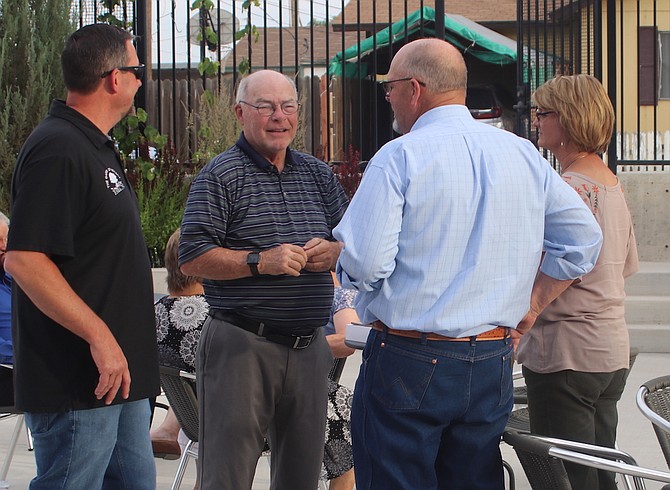 Bus Scharmann, second from left, who spent more than five decades of public service to Churchill County, speaks to, from left, Ryan Swirzcek, Pete Olsen and Tami Olsen at a gathering to honor the former Western Nevada College dean and county commissioner.