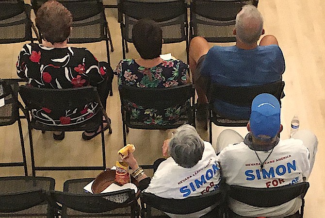 A couple wearing matching Fred Simon for Governor shirts attend a Town Hall in Minden on Wednesday.