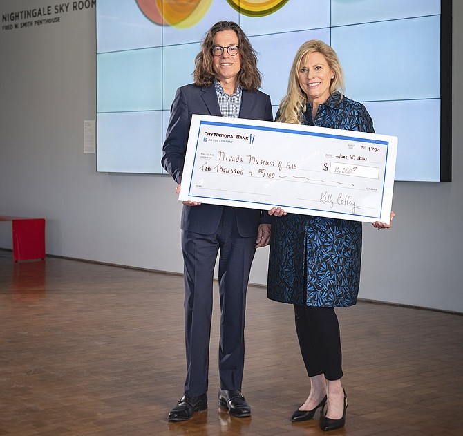 Janet Mello, senior vice president and Northern Nevada private banking team lead for City National Bank, presents David Walker, CEO of the Nevada Museum of Art, with $10,000 for its support of the museum’s STEAM Initiative.