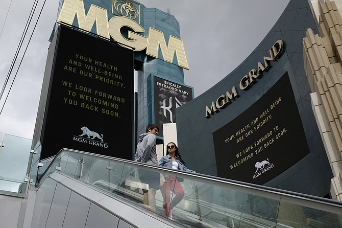 A couple ride the escalator outside The MGM Grand hotel-casino in Las Vegas on March 16, 2020. (Photo: John Locher/AP, file)