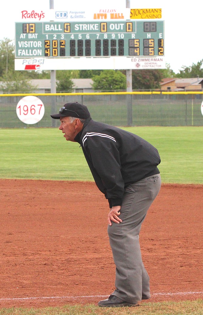 With the scoreboard in the background, Jack Beach umpires a baseball game at the 2018 Regional Tournament that was held in Fallon.