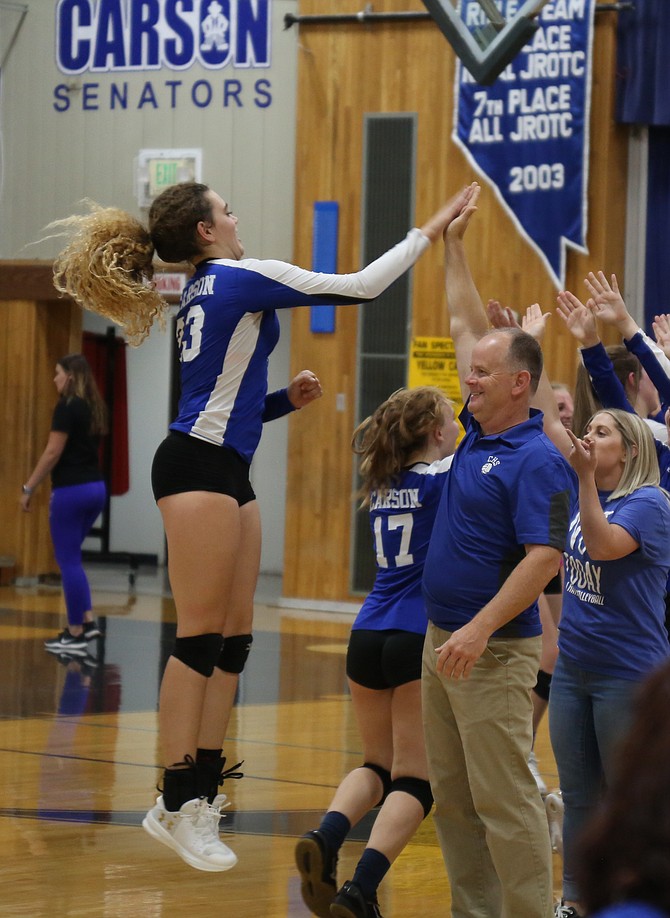 Robert Maw high fives Cami Larkin during a game in the fall of 2019. Maw stepped down as the Senators' volleyball coach this week after being in charge of the program since 2007.