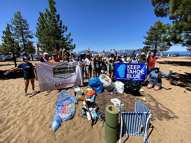 Volunteers take a break for a photo op on Nevada Beach on Monday after picking up three-quarters of a ton of trash.