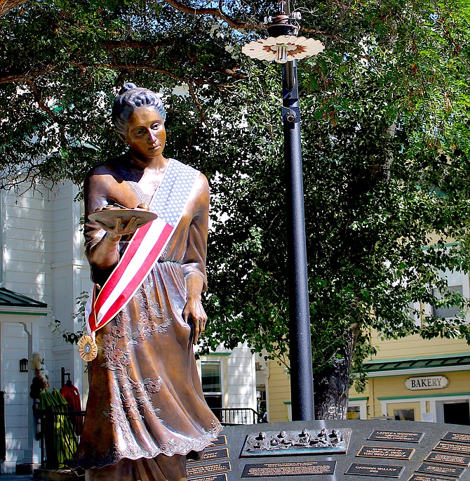 The statue of Candy Dance co-founder Lillian Virgin Finnegan adorned in Fourth of July sash on July 4 in Genoa, Nevada's oldest town.