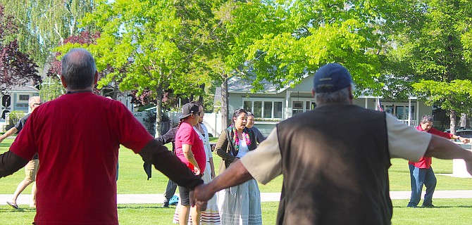 Protesters against the Minden siren engage in a round dance at Minden Park in May.