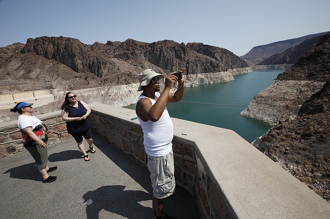 Eric Bonner of Lansing, Mich., visits the Hoover Dam in the Arizona side with his mother-in-law Zina Ibragimova, left, and his sister-in-law Gamar Ibragimovai, center, Thursday, July 15, 2021. (Photo: Chitose Suzuki/Las Vegas Review-Journal via AP)