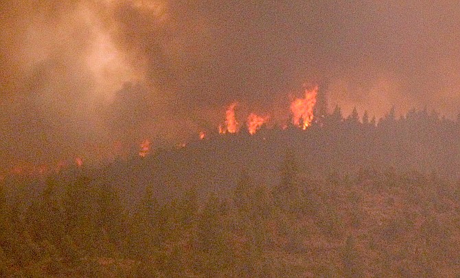 Flames can be seen from Highway 88 near Paynesville as they crest the ridge between Woodfords and Indian Creek Reservoir.