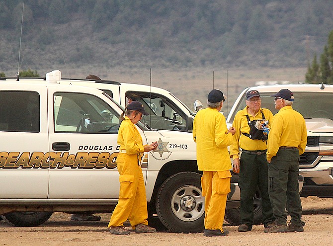 Douglas County Sheriff's Search and Rescue Team members prepare to notify Pine Nut residents of the approaching Tamarack Fire