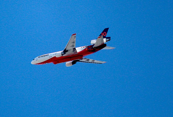 A DC-10 fire tanker circled over Carson Valley on Tuesday as clear skies permitted aerial firefighting to help slow down the Tamarack Fire.