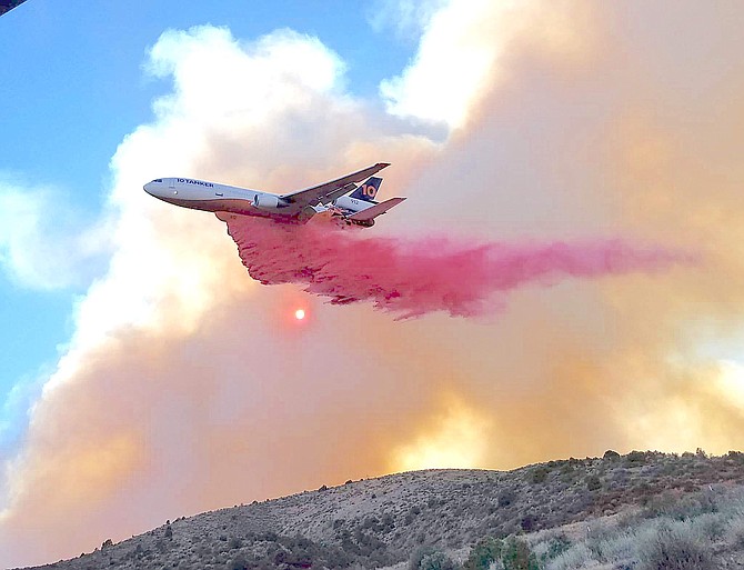 Crystal Damon took this photo of a fire bomber dropping retardant on the Tamarack Fire burning near Gold Hill north of Holbrook Junction on Thursday evening.