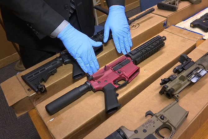 Sgt. Matthew Elseth with "ghost guns" on display at the headquarters of the San Francisco Police Department on Nov. 27, 2019. (AP Photo/Haven Daley, file)