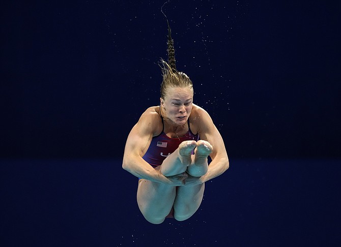 Krysta Palmer competes in women's diving 3m springboard preliminary at the Tokyo Aquatics Centre on Friday in Tokyo.