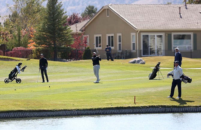 Golfers hit a shot over water during the 2019 PGA Q-School qualifier at Dayton Valley Golf course.