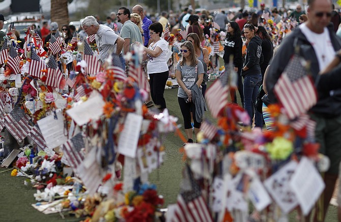 People visit a makeshift memorial honoring the victims of the Oct. 1 mass shooting on Nov. 12, 2017, in Las Vegas. (Photo: John Locher/AP, file)