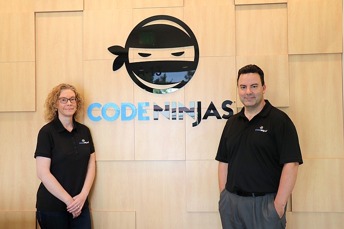 Christine Miller, left, and Eric Miller opened a Code Ninjas franchise after seeing the positive impacts coding and STEM education had on their own children.