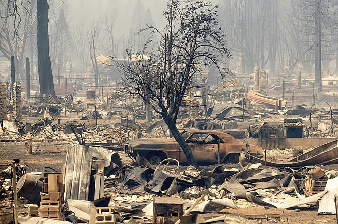 Homes and cars destroyed by the Dixie Fire line central Greenville on Thursday, Aug. 5, 2021, in Plumas County, Calif. (AP Photo/Noah Berger)