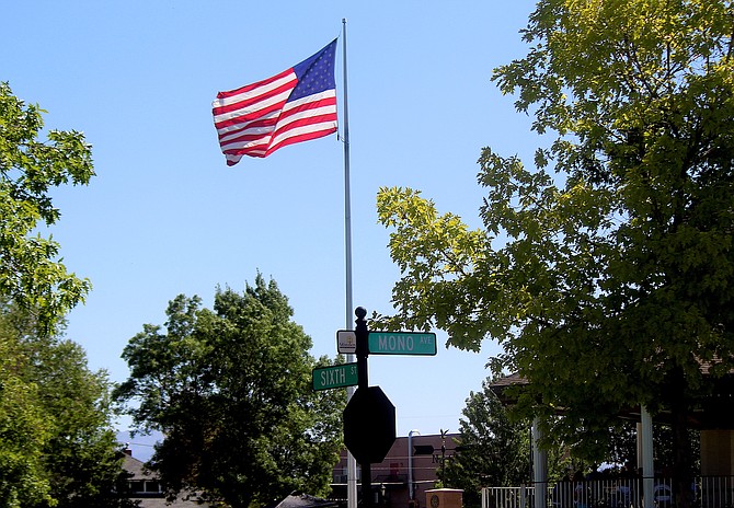 The breeze lofts the flag flying over Minden Park on Thursday during the Hot August Nights Poker Run