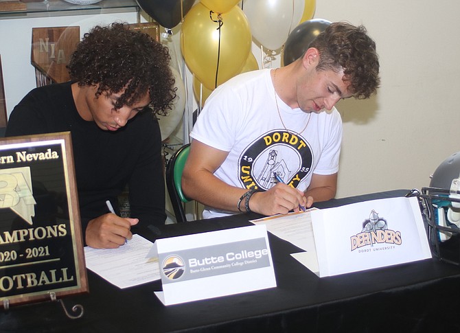 Fallon grads Levi Andrews, left, and Josiah Roserio sign their letters of intent to play football in college.