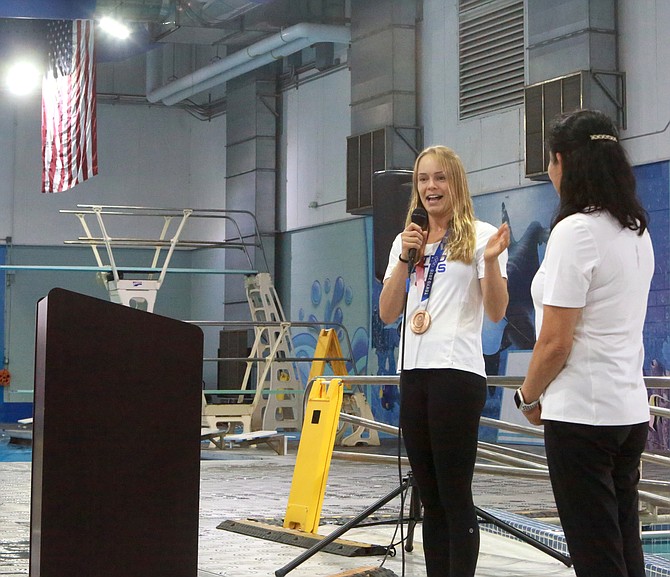 Krysta Palmer talks at Carson Valley Swim Center on Sunday. Behind Palmer is the first diving boards she learned how do dives off of. Sunday, she returned as an Olympic bronze medalist in diving.