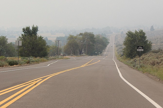 Jacks Valley Road fades into the smoke around noon on Sunday.