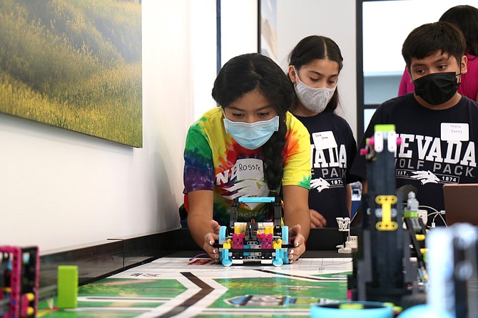 Sixth-grader Rossie Copdo prepares to use a robot made of LEGO pieces at the new K-12 Robotics Center, which opened Aug. 6, 2021, inside the Southside Studio in downtown Reno.