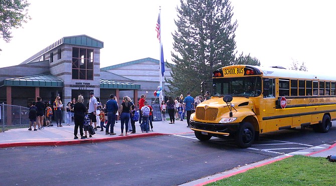 A Carson City School District bus makes a stop at Mark Twain Elementary School for Back to School Day Monday, Aug. 16, 2021. (Photo: Jessica Garcia/Nevada Appeal)