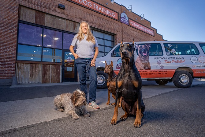 Malaika Heinbaugh, owner of Dog Gone Amazing, stands in front of her dog training and boarding business.