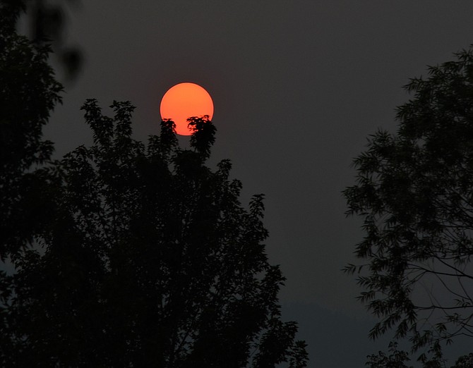 The sun glowed an angry red on Tuesday as smoke from the Calder Fire poured into Carson Valley. Tim Berube Photo