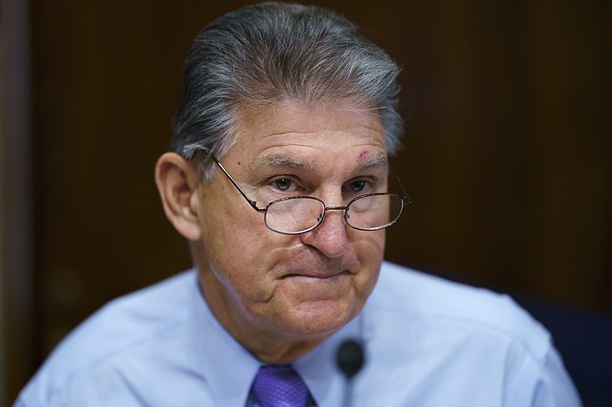 Sen. Joe Manchin, D-W.Va., prepares to chair a hearing in the Senate Energy and Natural Resources Committee at the Capitol in Washington on Aug. 5, 2021. (AP Photo/J. Scott Applewhite)