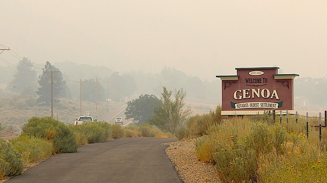 Genoa is barely visible through the smoke from the sign welcoming visitors.