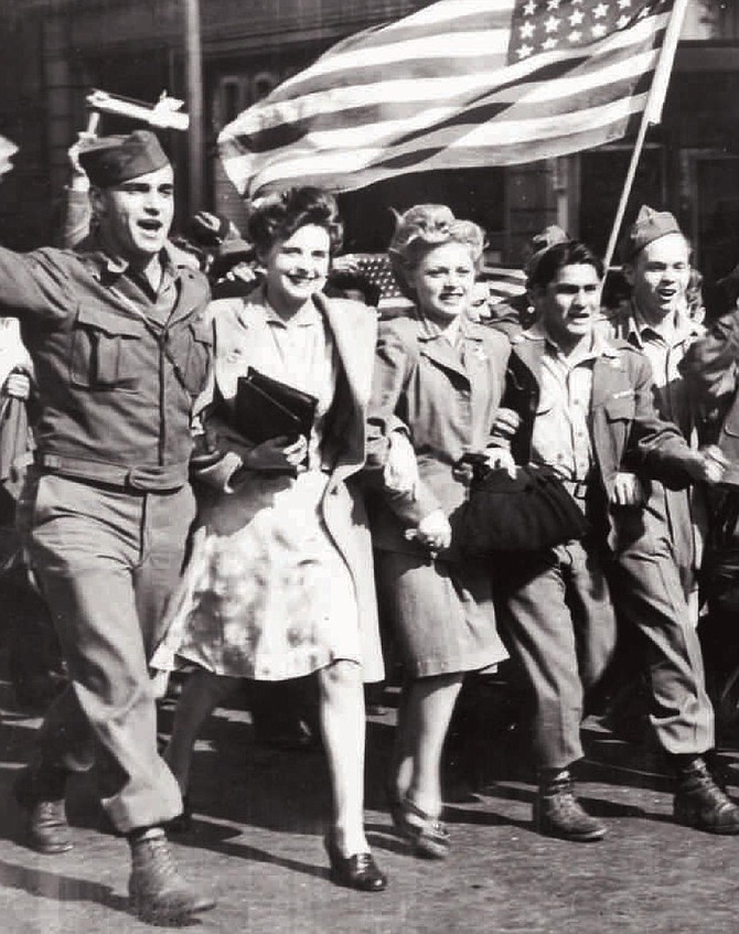 Two Parisienne women have "latched" on to three American GIs to lead the celebration, Paris is liberated from the "Boches."