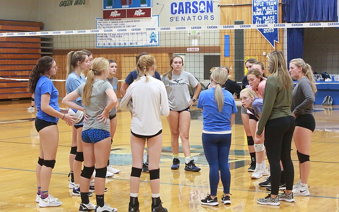 The Carson High volleyball team circles around at the end of practice Wednesday afternoon. The Senators will have a full schedule this fall under new head coach Brittany Witter.