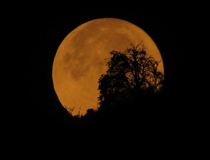 Saturday night's blue moon was more of an angry orange in this photo by Topaz Ranch Estates resident John Flaherty