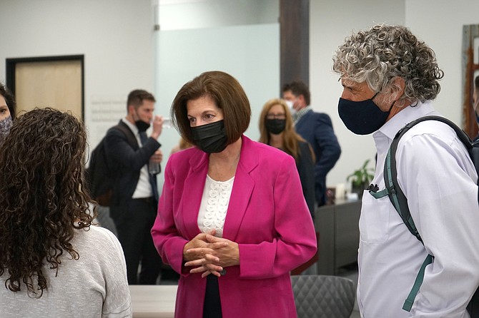 Sen. Catherine Cortez Masto, D-Nev., center, meets with people after speaking at the Reno-Sparks Chamber of Commerce in Reno on Aug. 23, 2021. (AP Photo/Samuel Metz.)