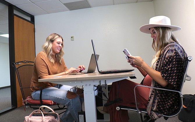 Sarah Almaraz, left, and Ashley Polan of local social media marketing agency Honeypot Social spend their first afternoon working at Reno Hive’s new coworking space on Moana Lane on Aug. 10, 2021.