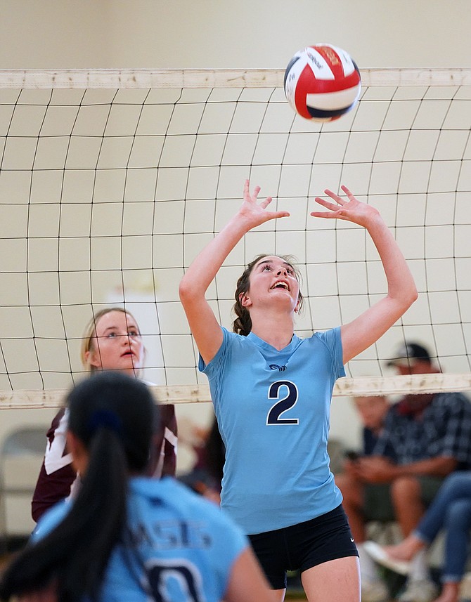 Oasis Academy’s Madison Darst sets the ball in Friday’s game against Elko in Yerington.