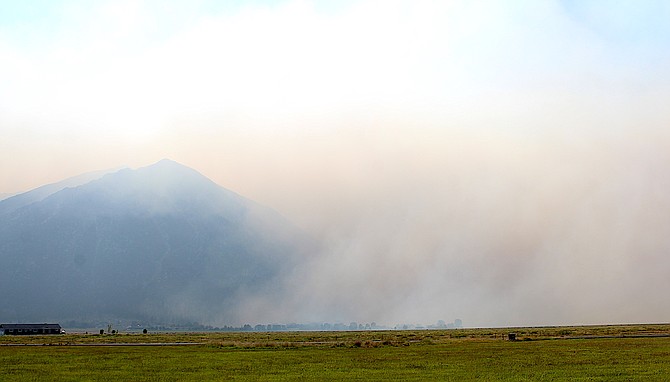 Smoke pouring into Carson Valley from near Jobs Peak almost looks like a separate fire is burning along the base.