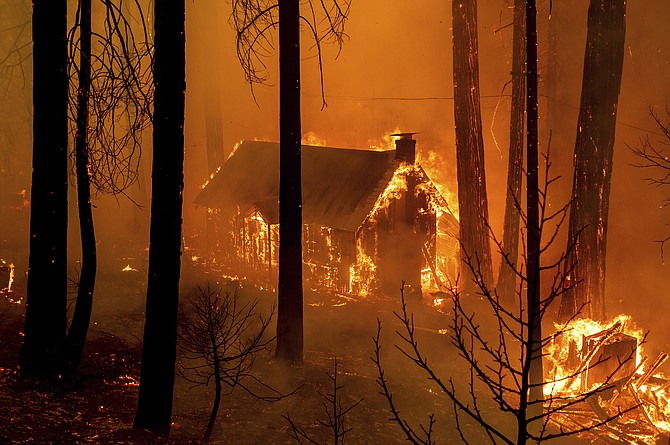 Flames from the French Fire consume a cabin on Highway 155 in Sequoia National Forest, Calif., on Wednesday, Aug. 25, 2021. (AP Photo/Noah Berger)