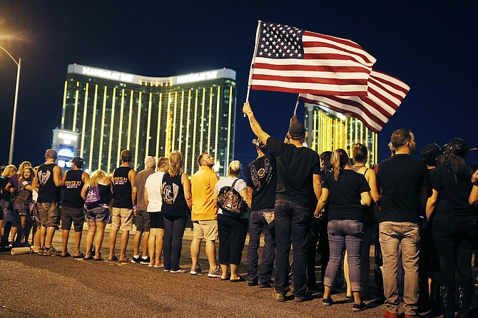 People form a human chain Oct. 1, 2018, around the shuttered site of the Las Vegas massacre. (Photo: John Locher/AP, file)