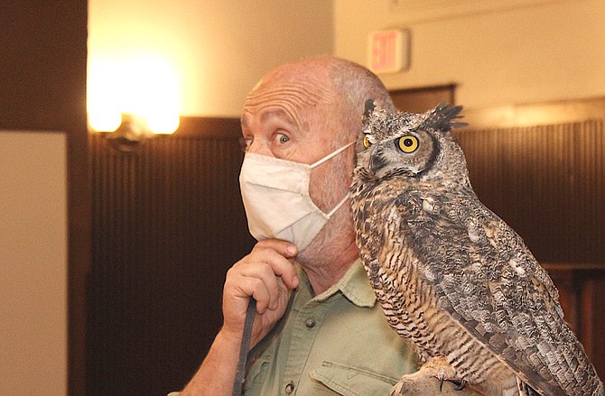 Gabe Kerschner shows Archimedes, the great horned owl to children in the CVIC Hall on Thursday.