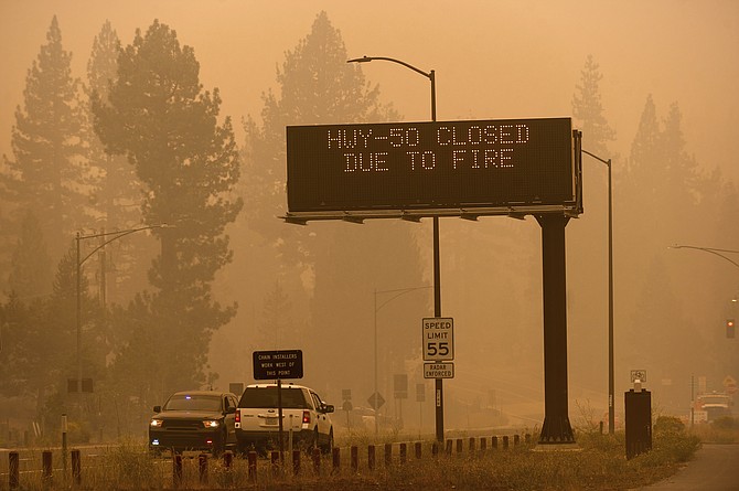 A sign in Eldorado County, Calif., warns motorists about the closure of Highway 50, which is shut in both directions due to the Caldor Fire, on Friday, Aug. 27, 2021. (AP Photo/Noah Berger)