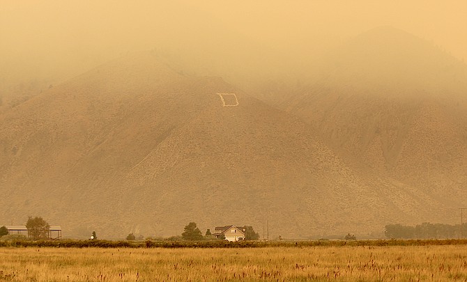 Smoke builds up in Carson Valley from the Caldor Fire on Sunday.