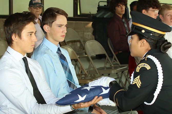 Sgt. Christina Aguilar of the Nevada Army National Guard presents the U.S. flag to Dominic Damonte, left, at the August unaccompanied service at the Northern Nevada Veterans Memorial Cemetery in Fernley. (Photo: Steve Ranson/LVN)
