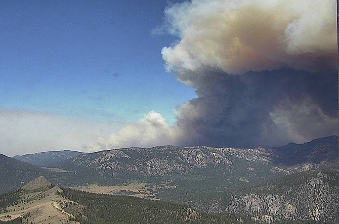 Smoke boils up from the Caldor Fire on the Hawkins Peak fire camera at 11:20 a.m. Tuesday.