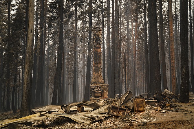 A chimney stands on a property destroyed by the Caldor Fire near South Lake Tahoe, Calif., Tuesday, Aug. 31, 2021. (AP Photo/Jae C. Hong)